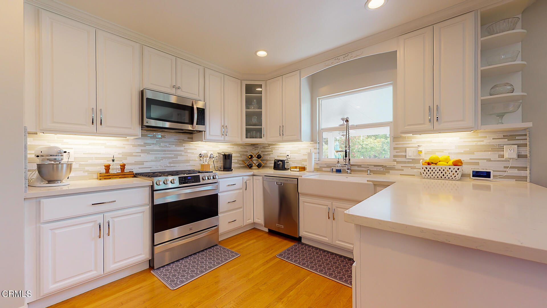 11052 Corley Drive Whittier, CA 90604 - Photo 10 of 39 a kitchen with granite countertop a sink a stove top oven and white cabinets