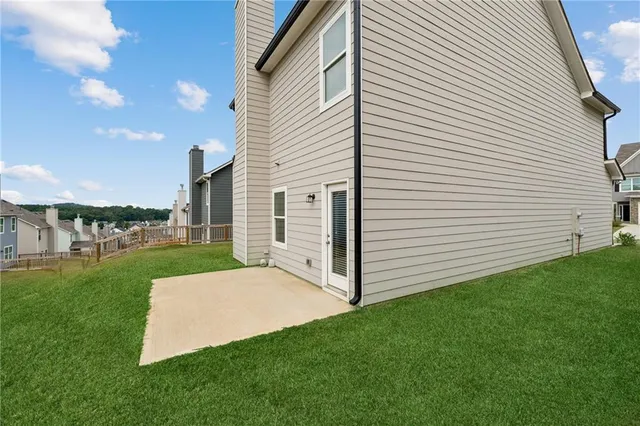 a view of a white house with a garden