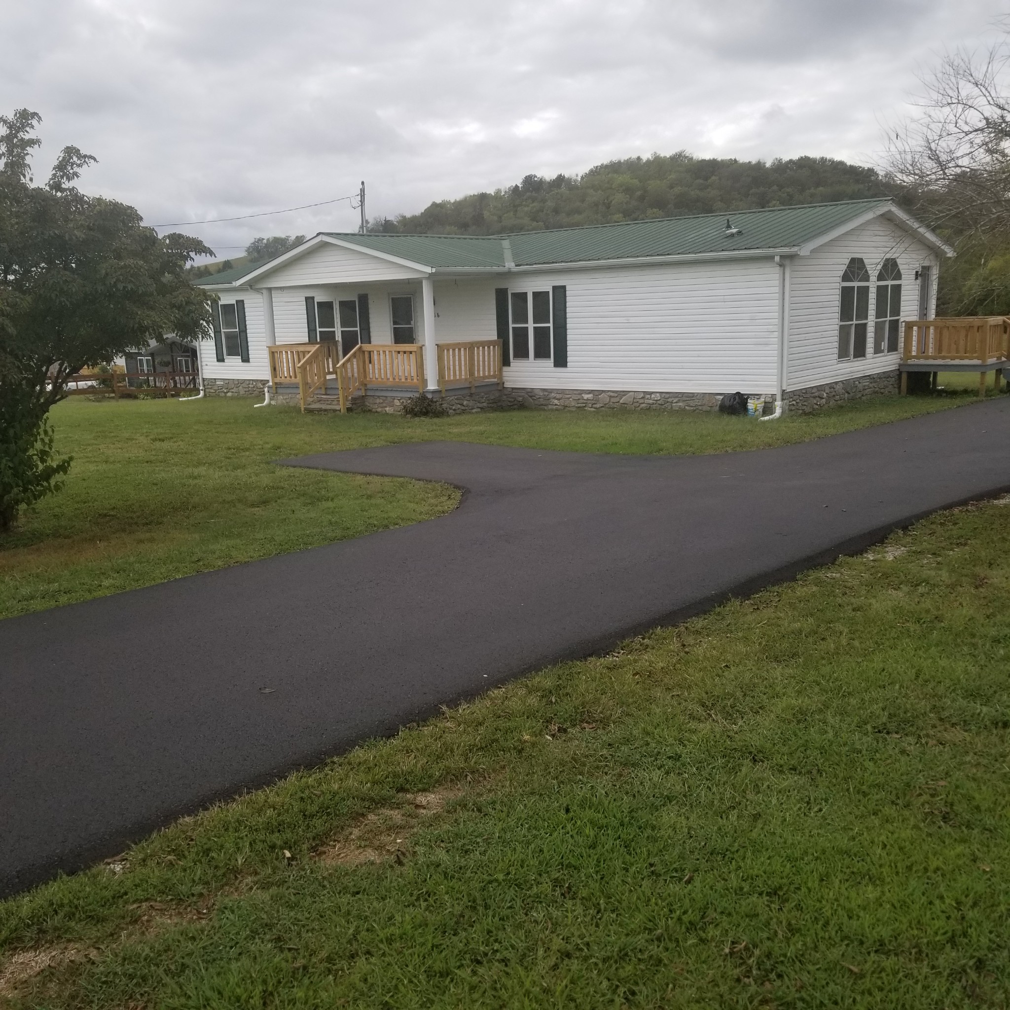 5118 New Harmony Road Hartsville, TN 37074 - Photo 1 of 13 a front view of a house with a garden and yard