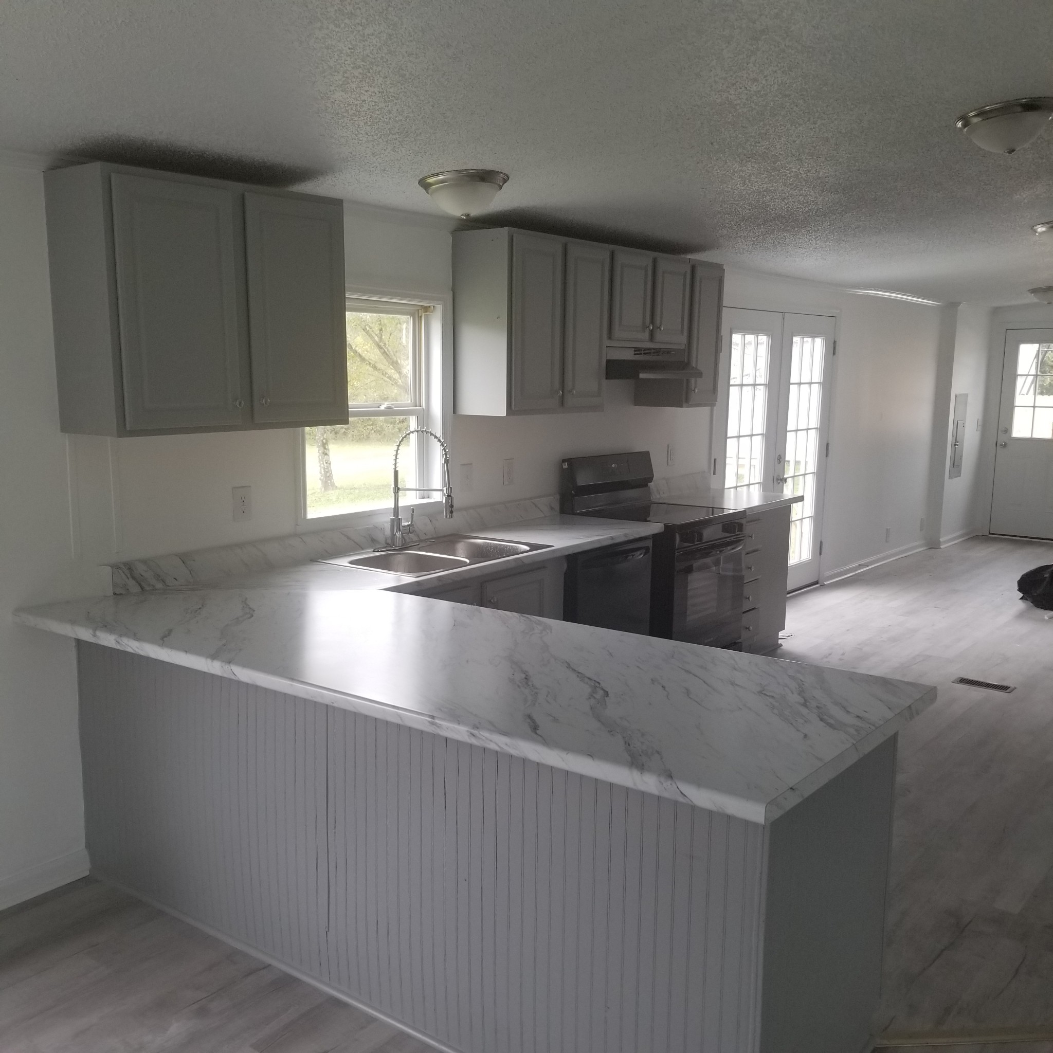 5118 New Harmony Road Hartsville, TN 37074 - Photo 3 of 13 a large kitchen with granite countertop a sink a counter space appliances and cabinets