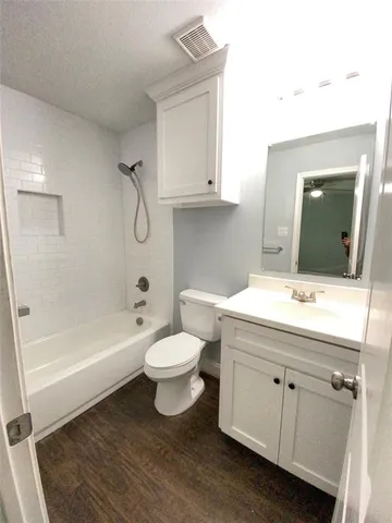 a bathroom with a sink a toilet and bathtub