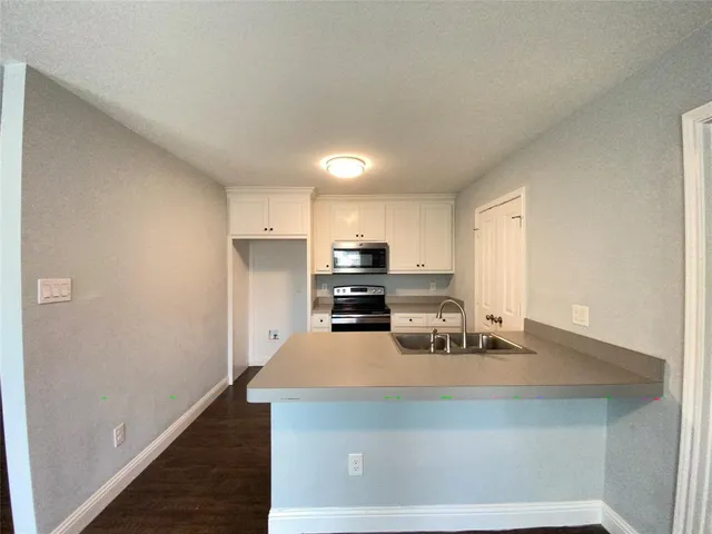 a kitchen with stainless steel appliances a sink stove and refrigerator