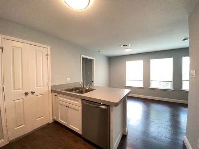 a kitchen with a sink stove and cabinets