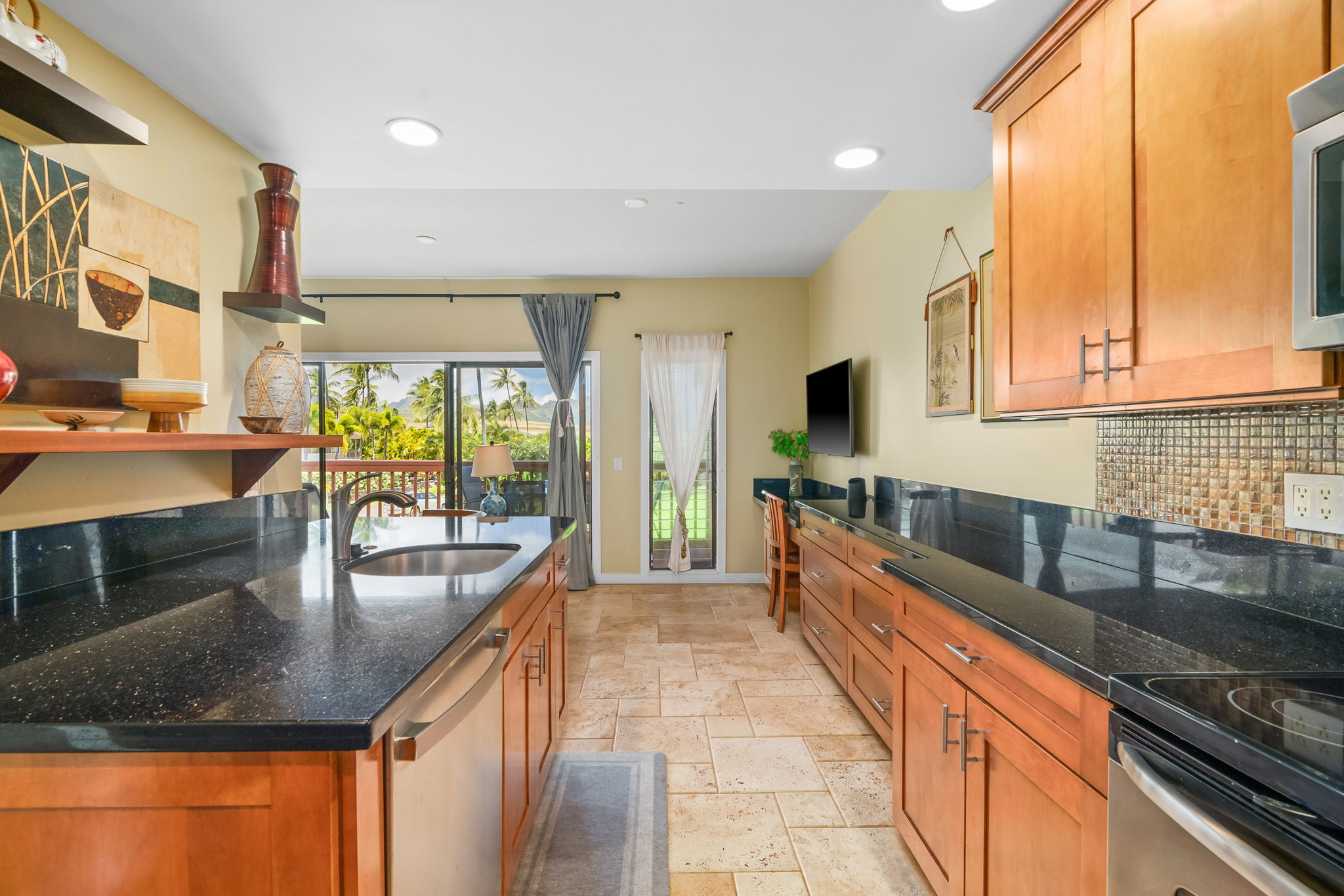 2370 Ho'ohu Road, Unit 712 Koloa, HI 96756 - Photo 11 of 28 a large kitchen with stainless steel appliances granite countertop a lot of counter space and a sink