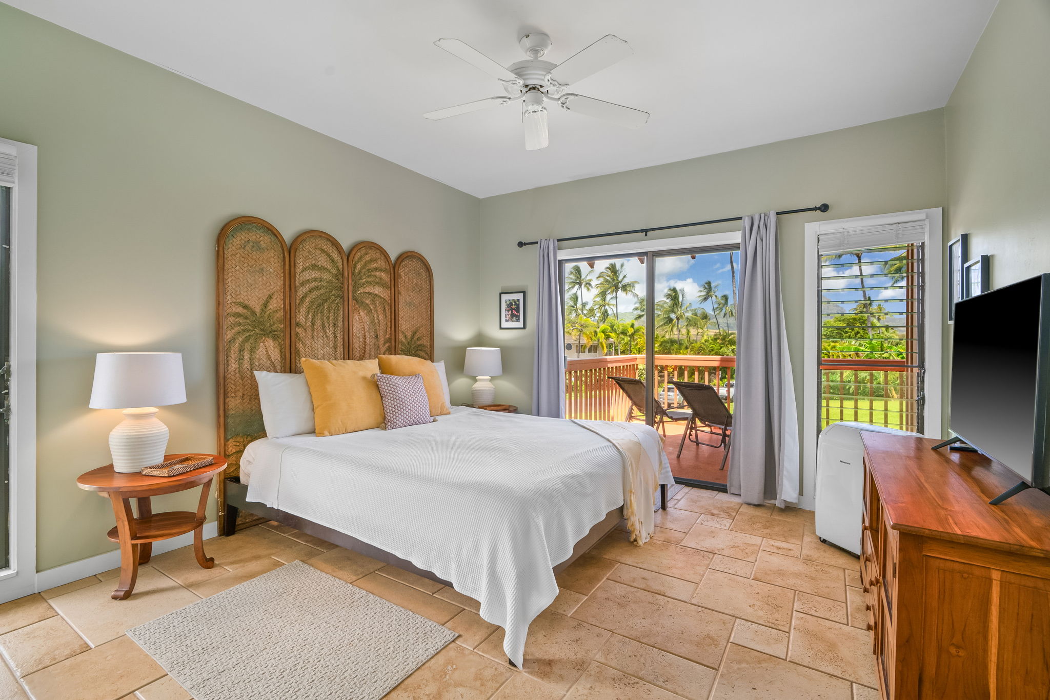 2370 Ho'ohu Road, Unit 712 Koloa, HI 96756 - Photo 16 of 28 a bedroom with a bed and glass windows