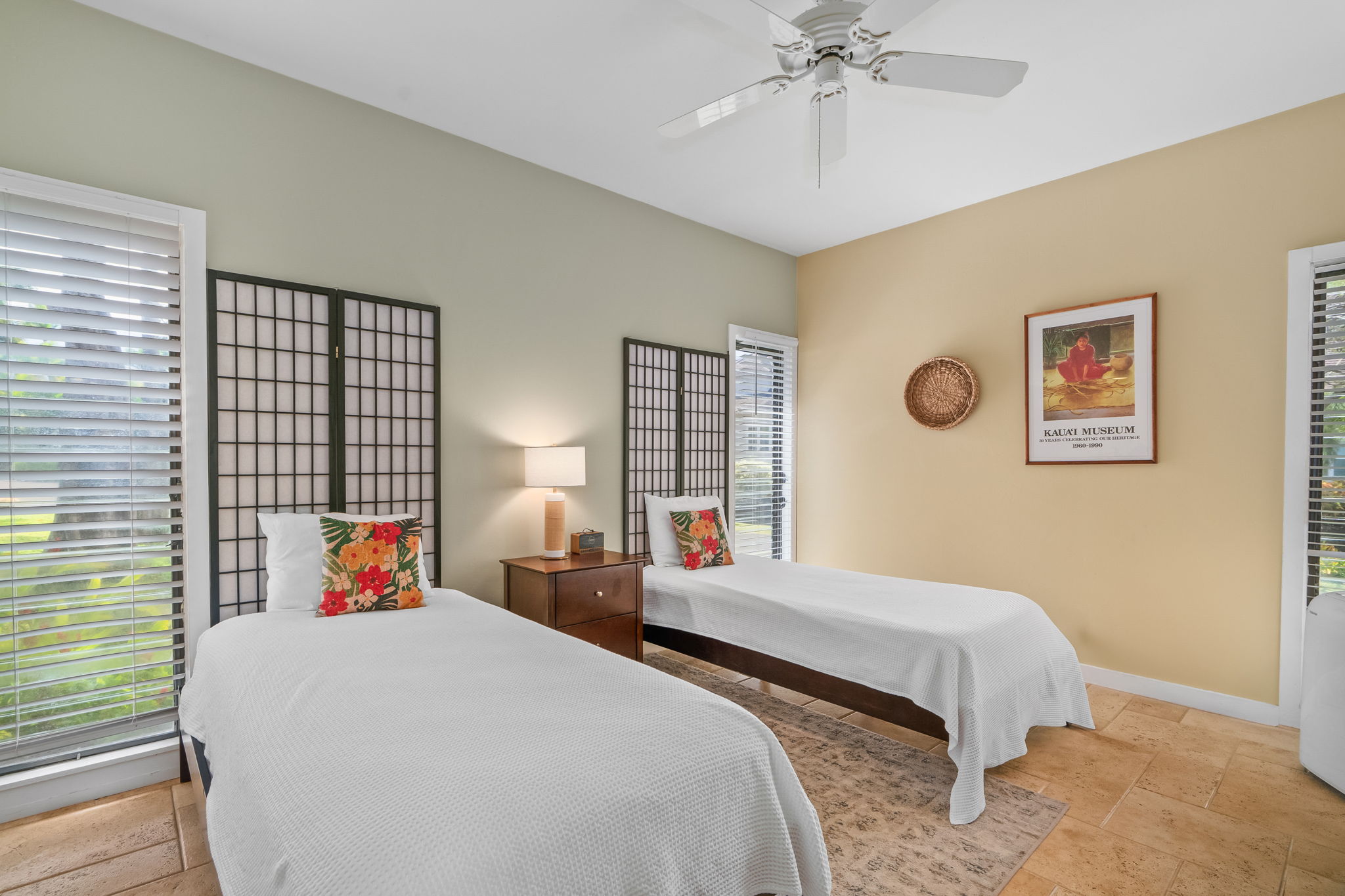 2370 Ho'ohu Road, Unit 712 Koloa, HI 96756 - Photo 20 of 28 a bedroom with two beds and a chandelier