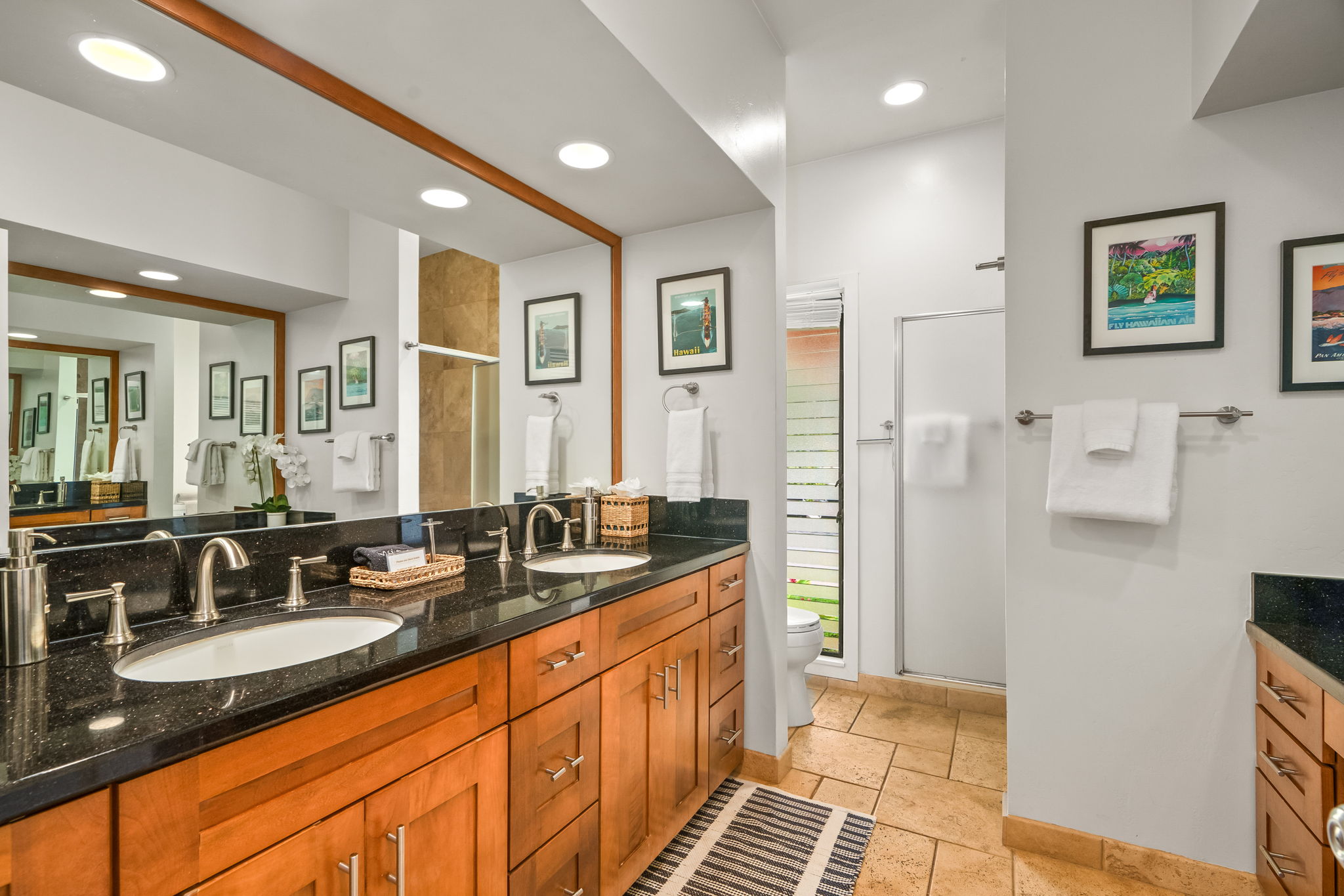 2370 Ho'ohu Road, Unit 712 Koloa, HI 96756 - Photo 22 of 28 a large bathroom with double vanity sink a mirror and a shower