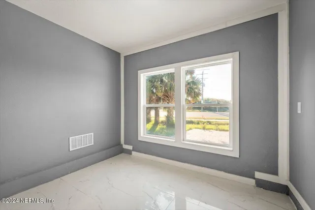 a kitchen with stainless steel appliances kitchen island granite countertop a sink a stove a refrigerator cabinets and a window