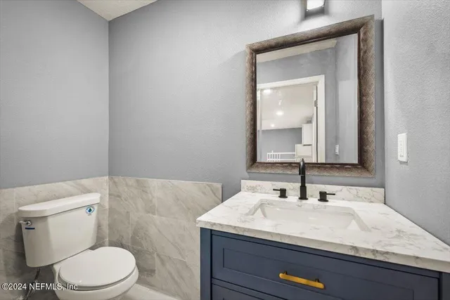 a kitchen with stainless steel appliances kitchen island granite countertop a stove a sink and a refrigerator