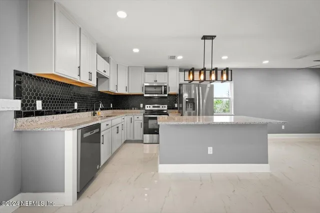 a view of a livingroom with a ceiling fan and window