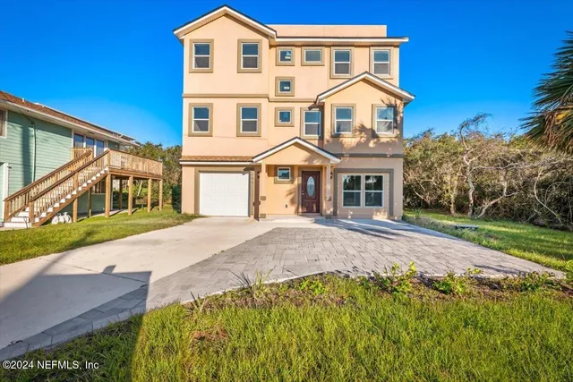 a front view of a house with a garden