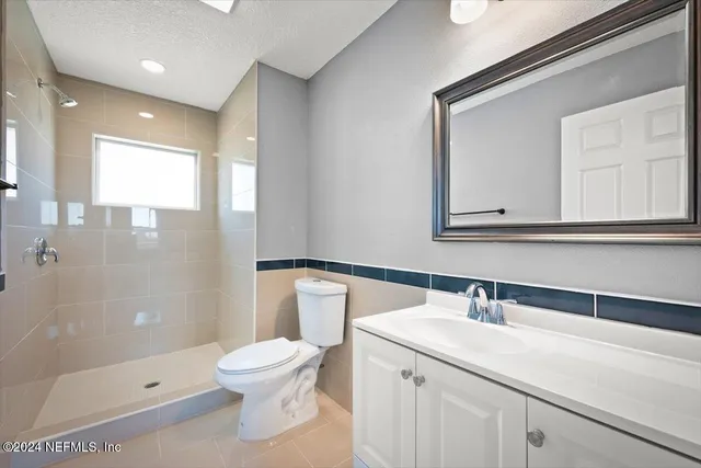 an aerial view of a residential houses with outdoor space and street view