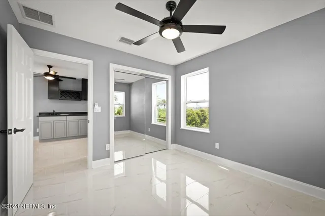 an aerial view of residential houses with outdoor space and trees