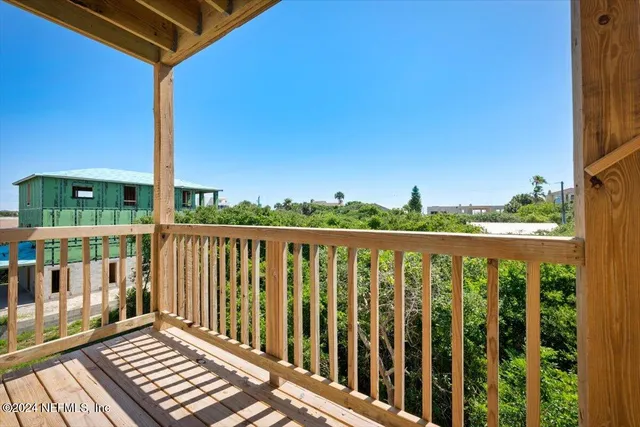 an aerial view of a house with yard and patio