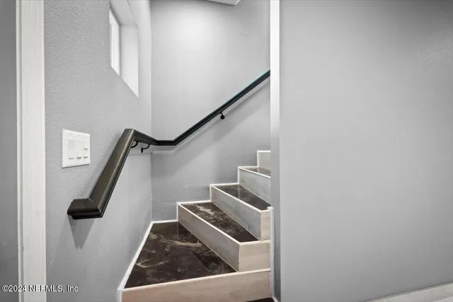 a kitchen with white cabinets and sink