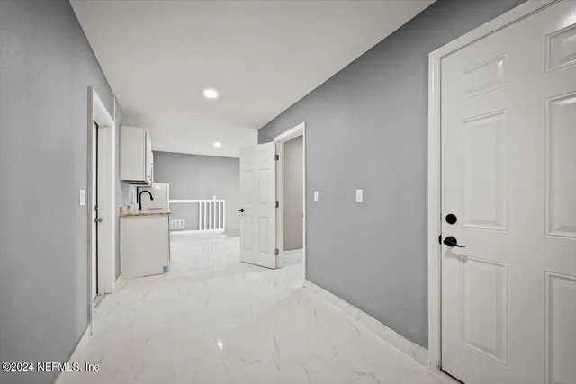 a spacious bathroom with a granite countertop sink mirror and a shower
