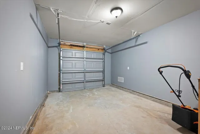 a view of an empty room with window and bathroom
