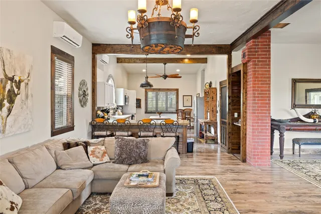 a living room with furniture and a chandelier