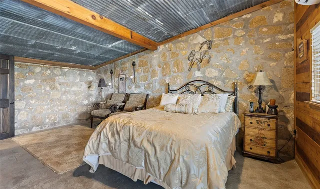 a bedroom with double bed and a window