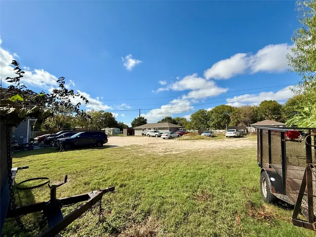 a view of a water fountain with wooden fence