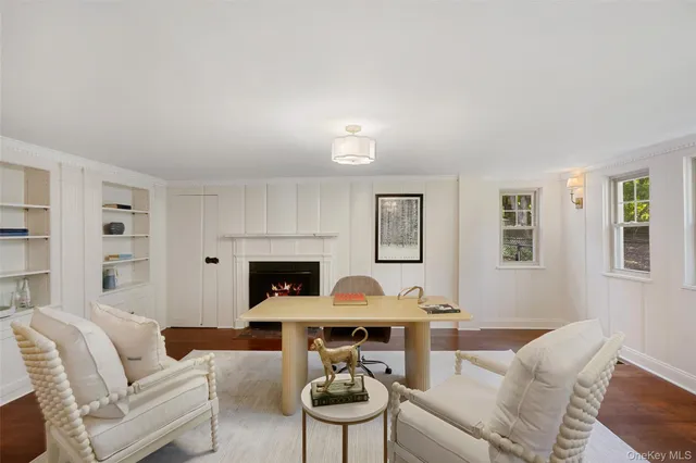 a living room with furniture a fireplace and a window
