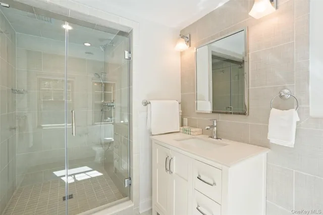 a bathroom with a sink a shower and a mirror