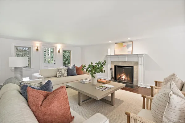 a living room with furniture a rug and a fireplace