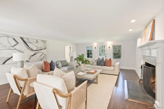 a living room with fireplace furniture and a wooden floor
