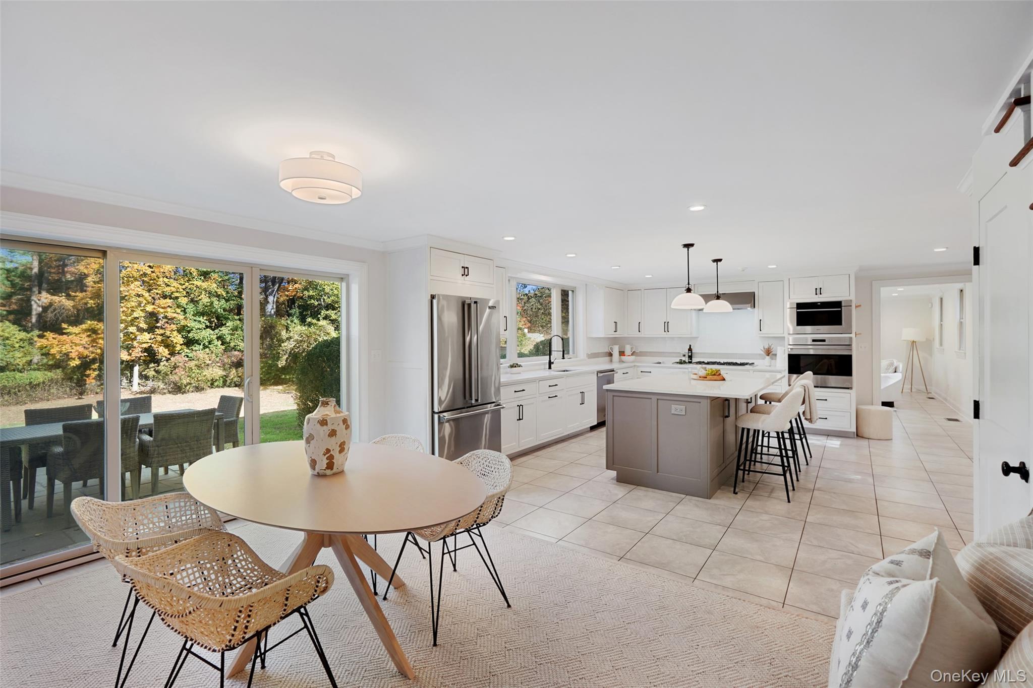 9 Oregon Road Bedford Corners, NY 10549 - Photo 9 of 35 a kitchen with a dining table chairs and refrigerator