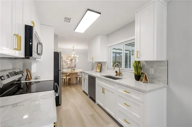a kitchen with a sink stove and cabinets