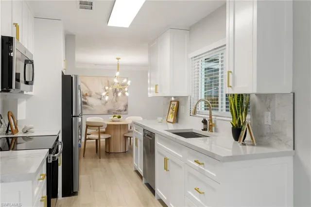 a kitchen with a sink stove and cabinets