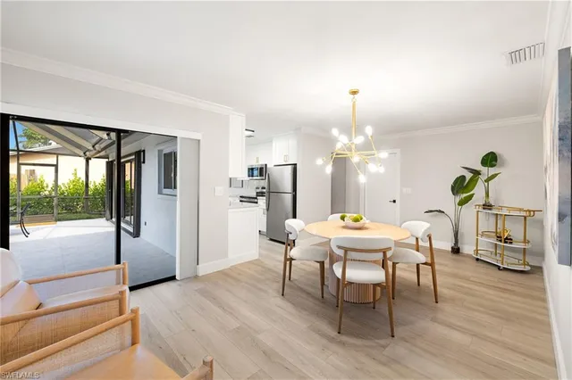 a dining room with furniture a livingroom and chandelier