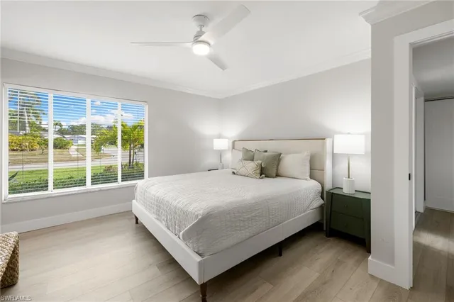 a large bed sitting in a bedroom next to a window