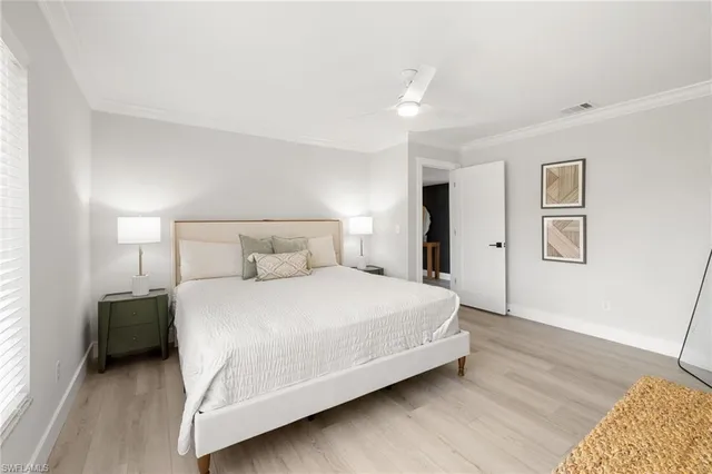 a bedroom with a bed and a night stand