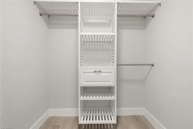 a bathroom with a walk in closet and a window