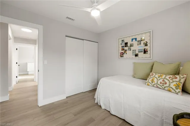 a bedroom with a large bed and a painting on the wall