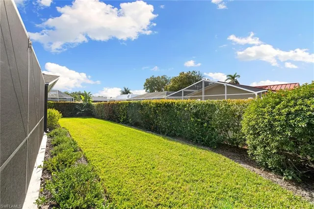 a view of a swimming pool with a yard