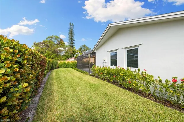 a view of a house with a backyard