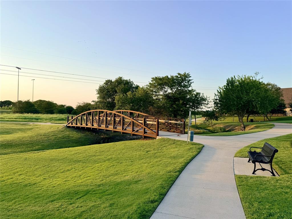 2721 Old Shire Path Road Prosper, TX 75078 - Photo 31 of 39 Community Paved pathways featuring a pedestrian bridge and surrounding green space