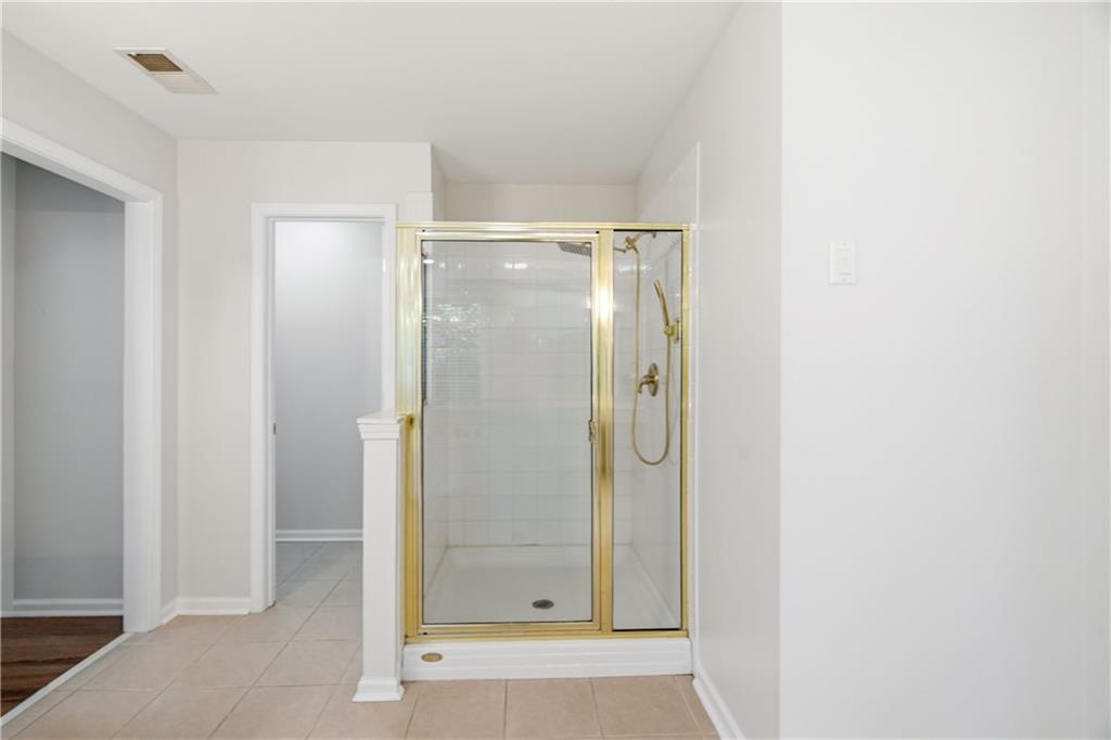 110 Mayes Farm Road Northwest Marietta, GA 30064 - Photo 26 of 49 a bathroom with a glass shower door