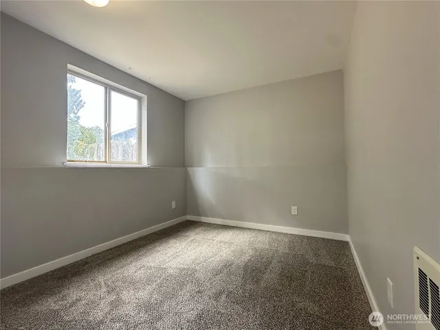 an empty room with closet area
