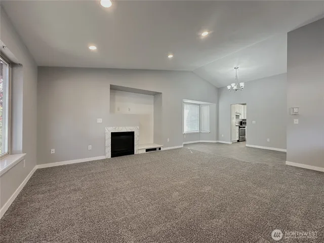 a view of a big room with a fireplace and window