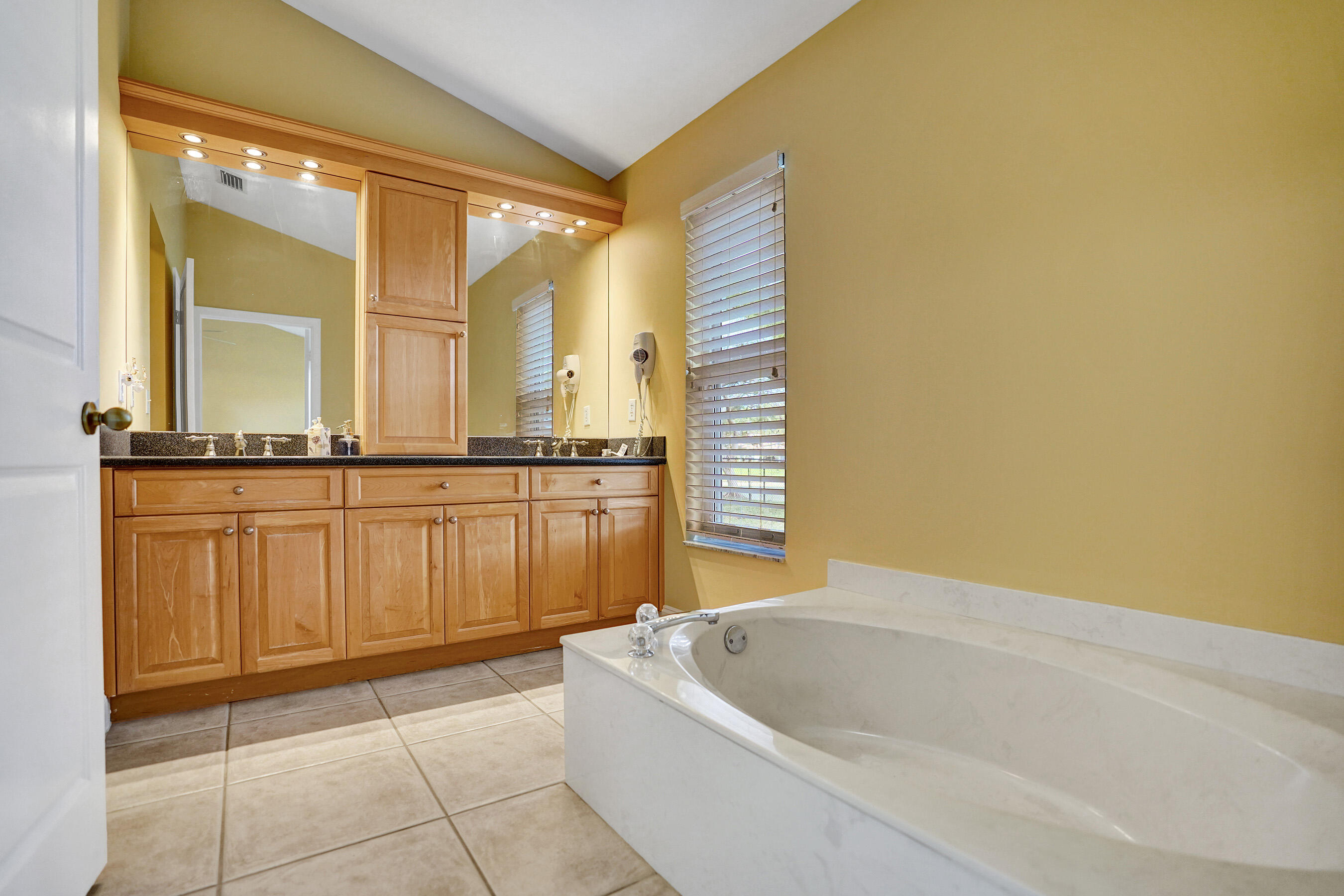 3825 Sabal Lakes Road Delray Beach, FL 33445 - Photo 16 of 33 a bathroom with a bathtub and shower