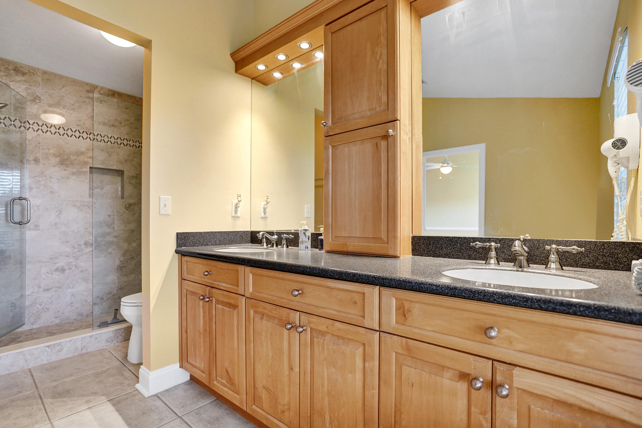 3825 Sabal Lakes Road Delray Beach, FL 33445 - Photo 17 of 33 a bathroom with a granite countertop double vanity sink a mirror and a bathtub