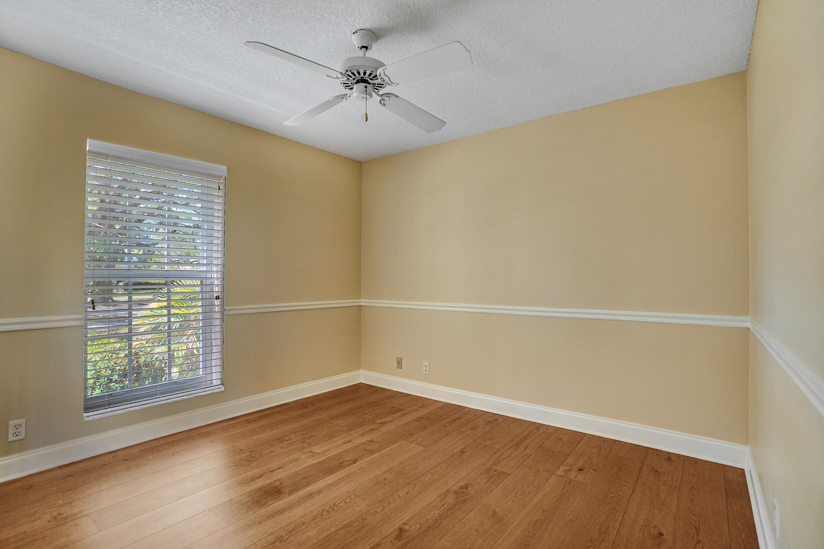 3825 Sabal Lakes Road Delray Beach, FL 33445 - Photo 20 of 33 wooden floor in an empty room with a window