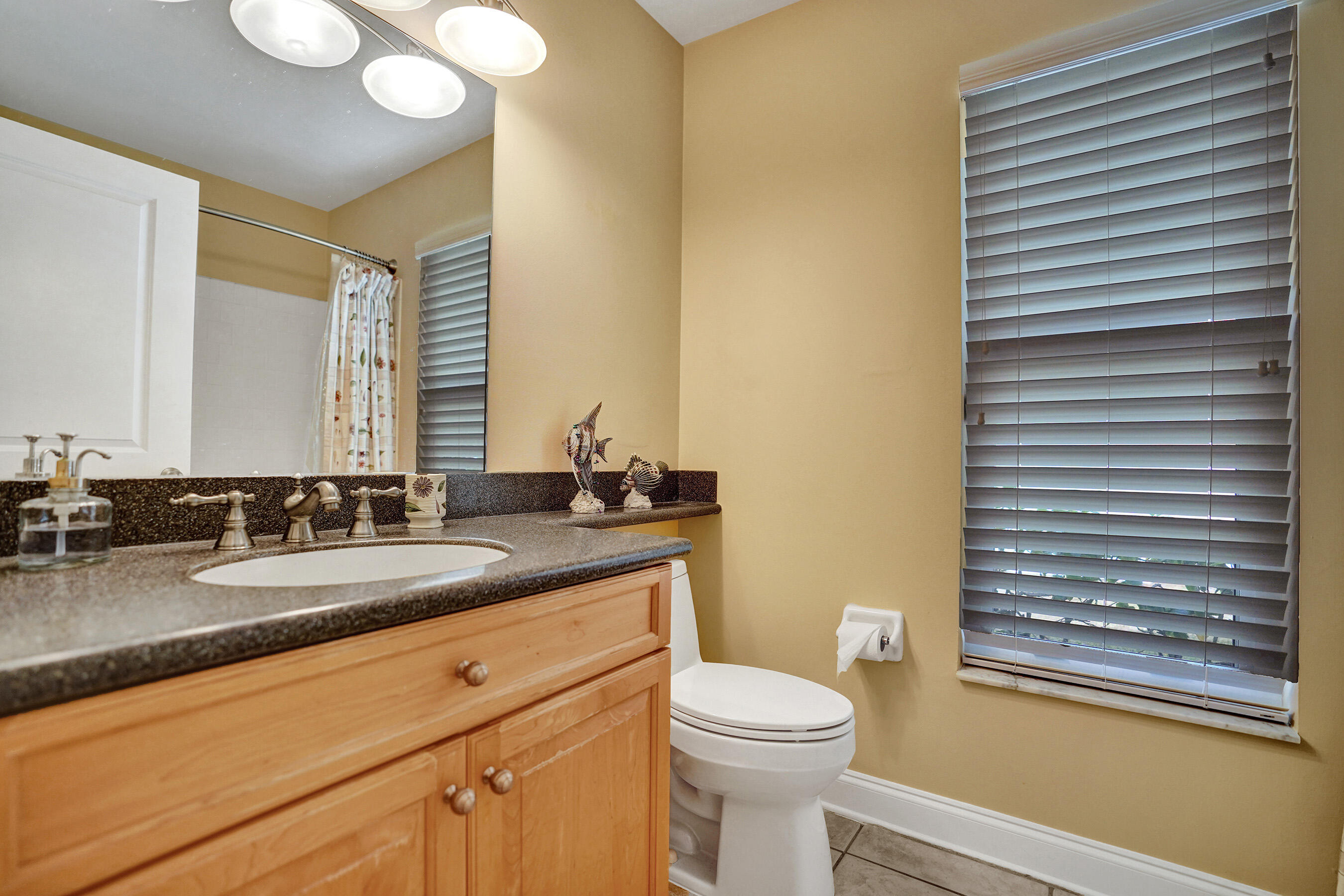 3825 Sabal Lakes Road Delray Beach, FL 33445 - Photo 22 of 33 a bathroom with a granite countertop sink toilet and mirror
