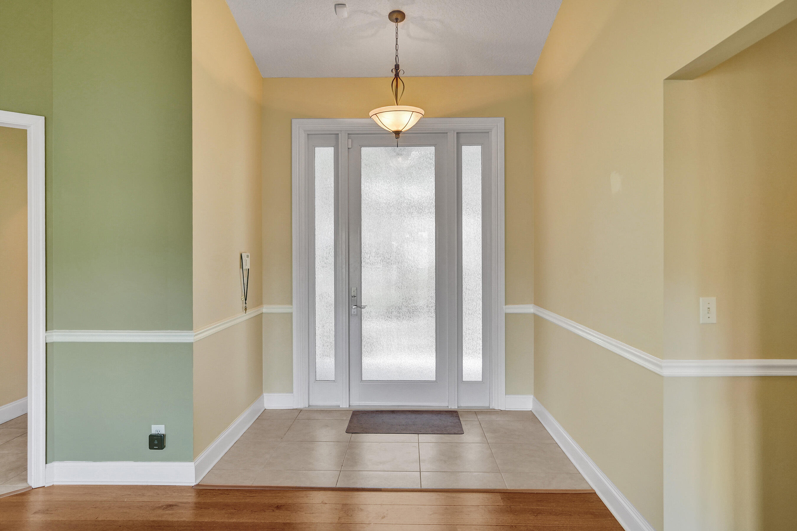 3825 Sabal Lakes Road Delray Beach, FL 33445 - Photo 3 of 33 a view of a hallway with wooden floor and entryway