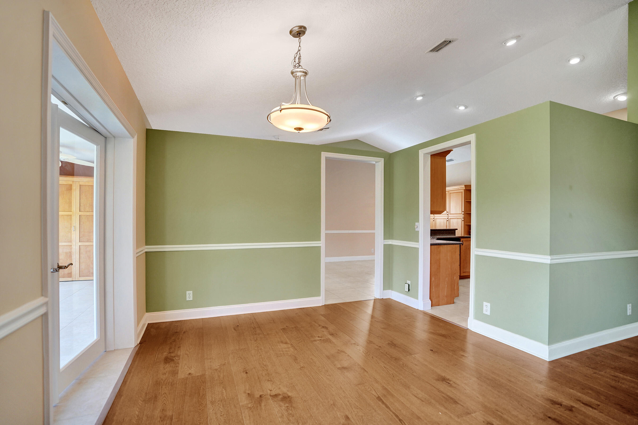 3825 Sabal Lakes Road Delray Beach, FL 33445 - Photo 6 of 33 wooden floor in an empty room with a window