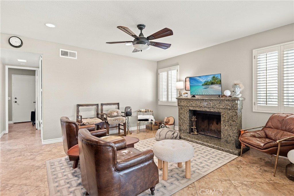 6933 Stanislaus Place Rancho Cucamonga, CA 91701 - Photo 14 of 54 a living room with furniture and a fireplace