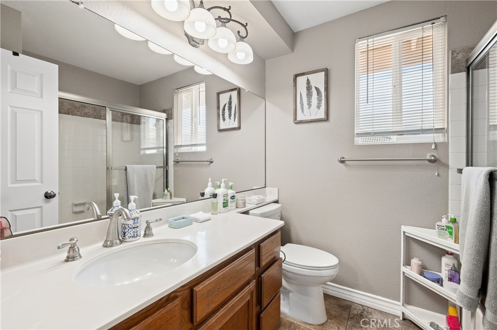 6933 Stanislaus Place Rancho Cucamonga, CA 91701 - Photo 28 of 54 a bathroom with a sink a toilet and a mirror